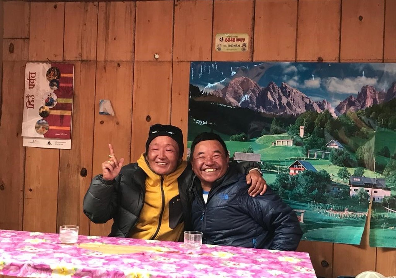 Two local Sherpa guides enjoying a local drink at a guesthouse.